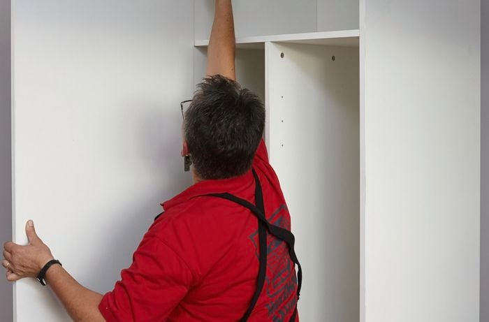 Person hanging door up.
