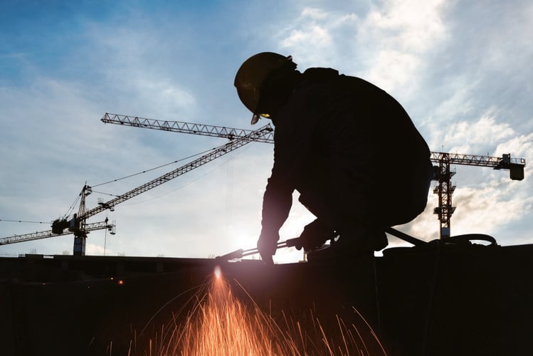 A construction worker using a welder on a building site