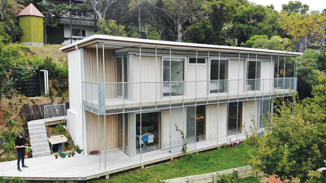 A two-storey house with timber cladding on a very steep site