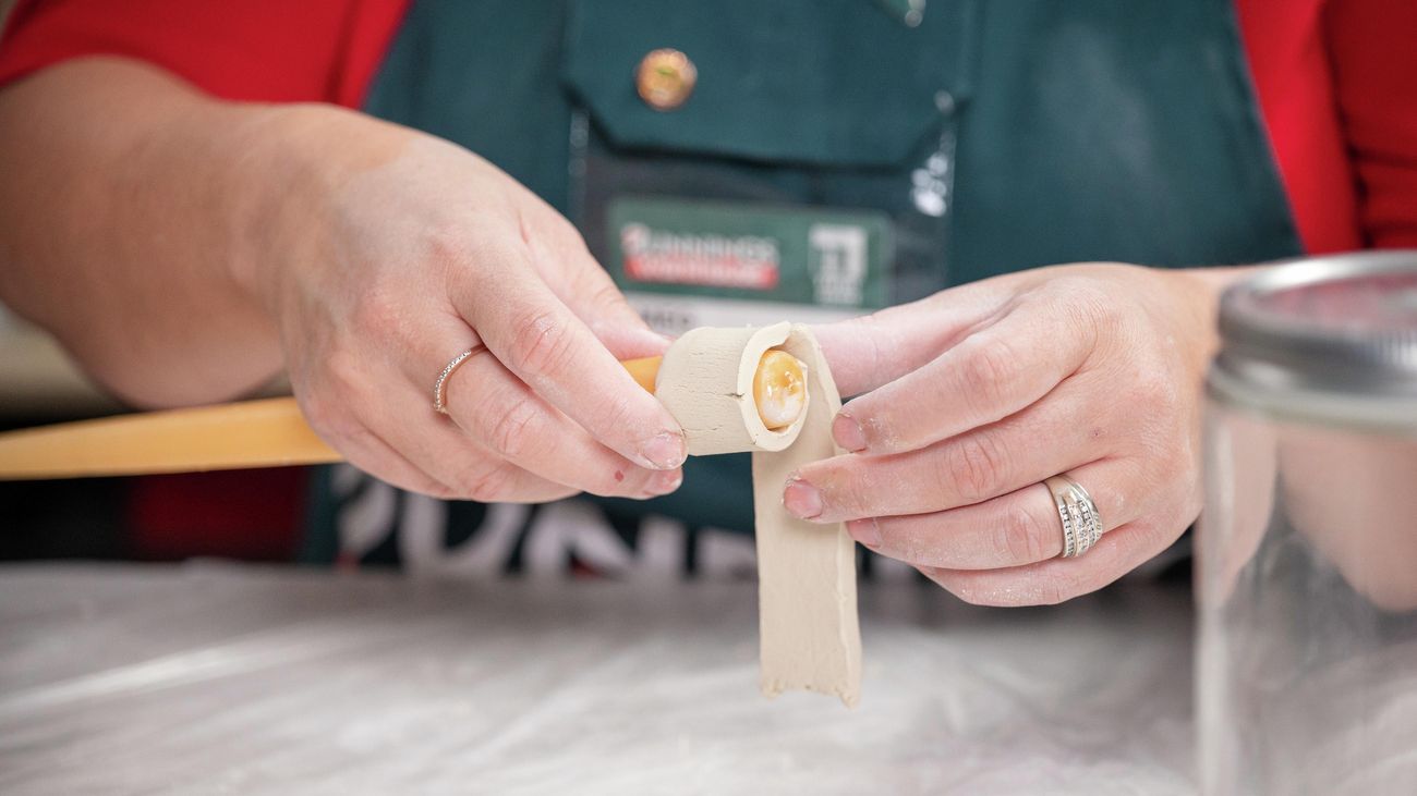 A bunnings team member making a candle holder.