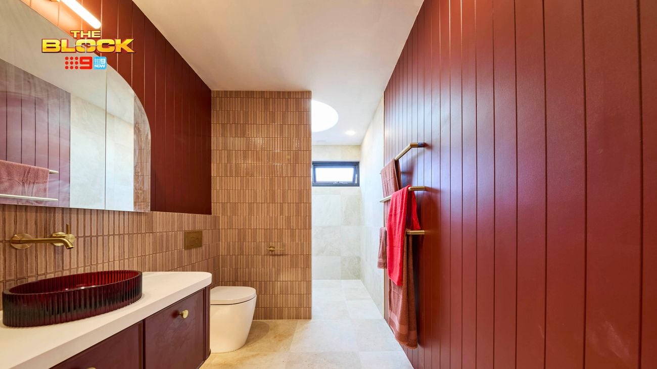 Bathroom with red panelled walls, walk-in shower, and modern vanity.
