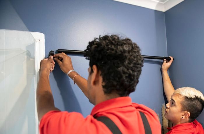 A bathroom rail being fitted to a wall