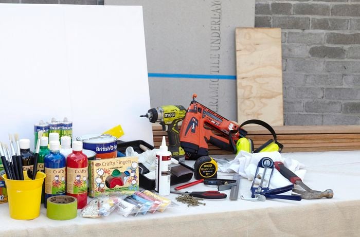 The tools and materials needed to create a DIY toddler activity board.