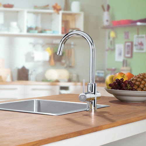 Kitchen benchtop with stainless steel sink and tapware