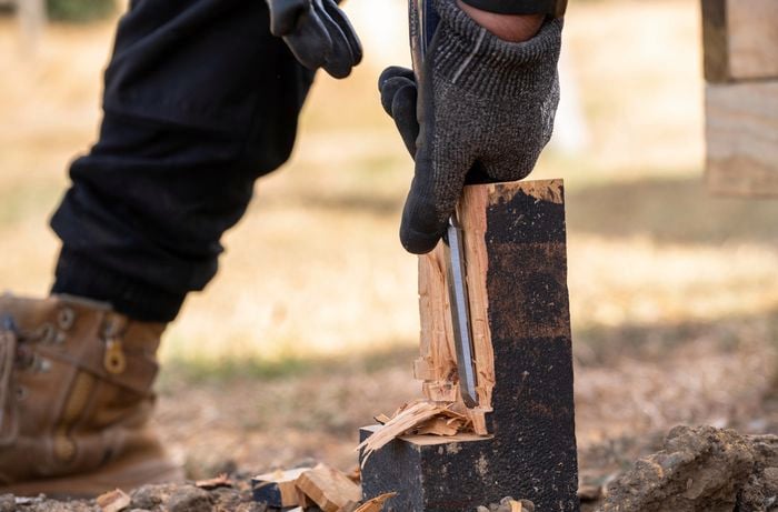 Excess wood being chiselled away from a stump