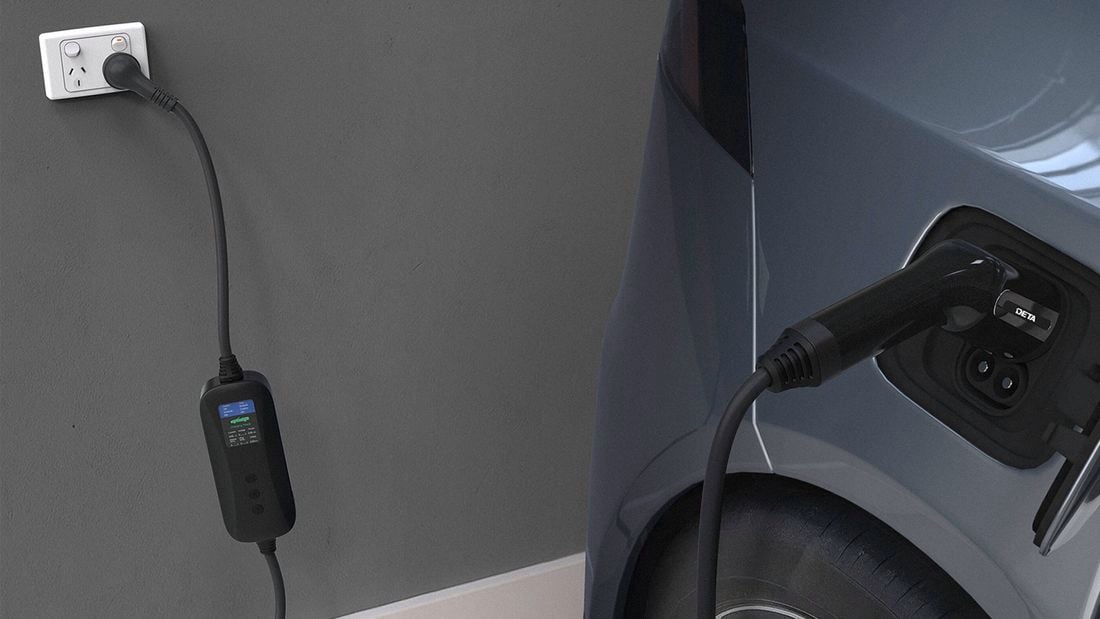 A Deta portable electric vehicle charger model with screen plugged into a car