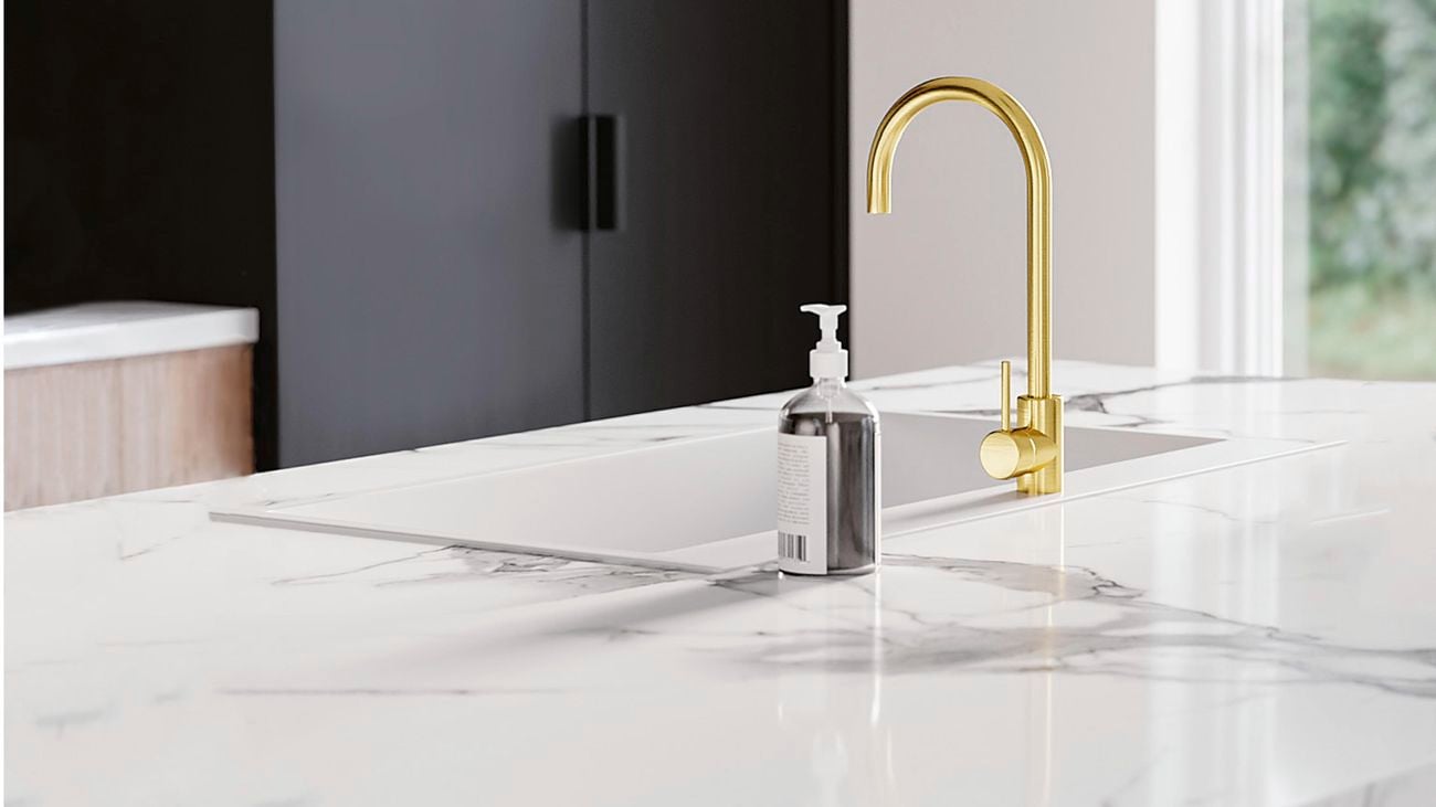 Close up of Kaboodle marble-look kitchen benchtop, sink and brushed brass sink mixer and hand wash