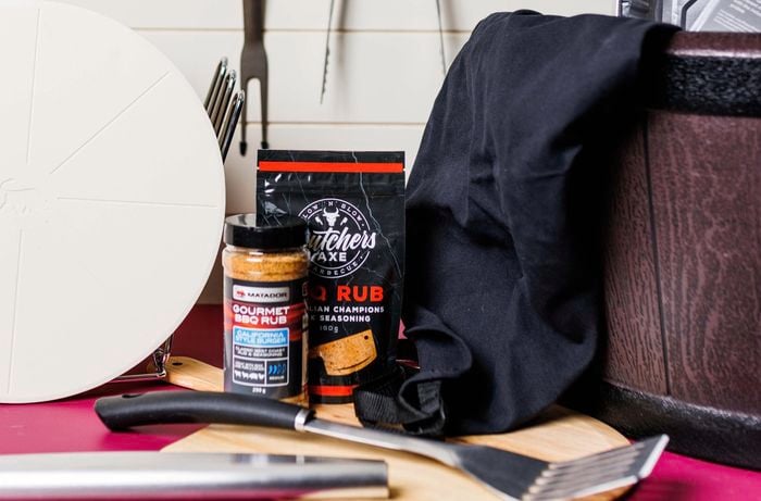 Close up of BBQ rub products and BBQ tools.