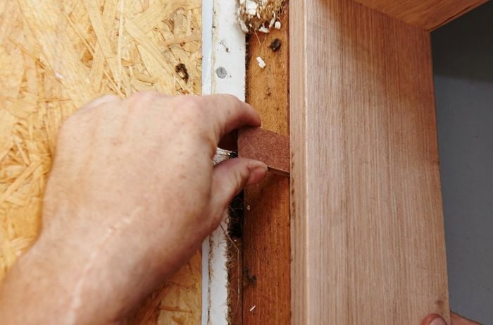 Packers being used to level one side of the door jamb