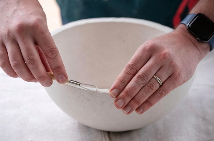 bunnings team member removing sharp edges using a clay sculpting tool