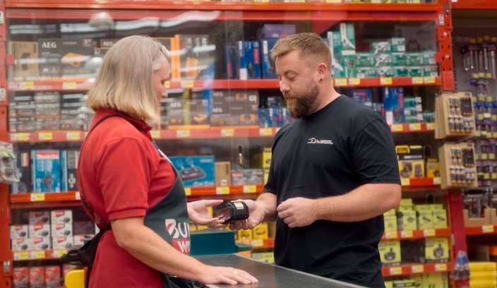 Bunnings team member serving a customer in store