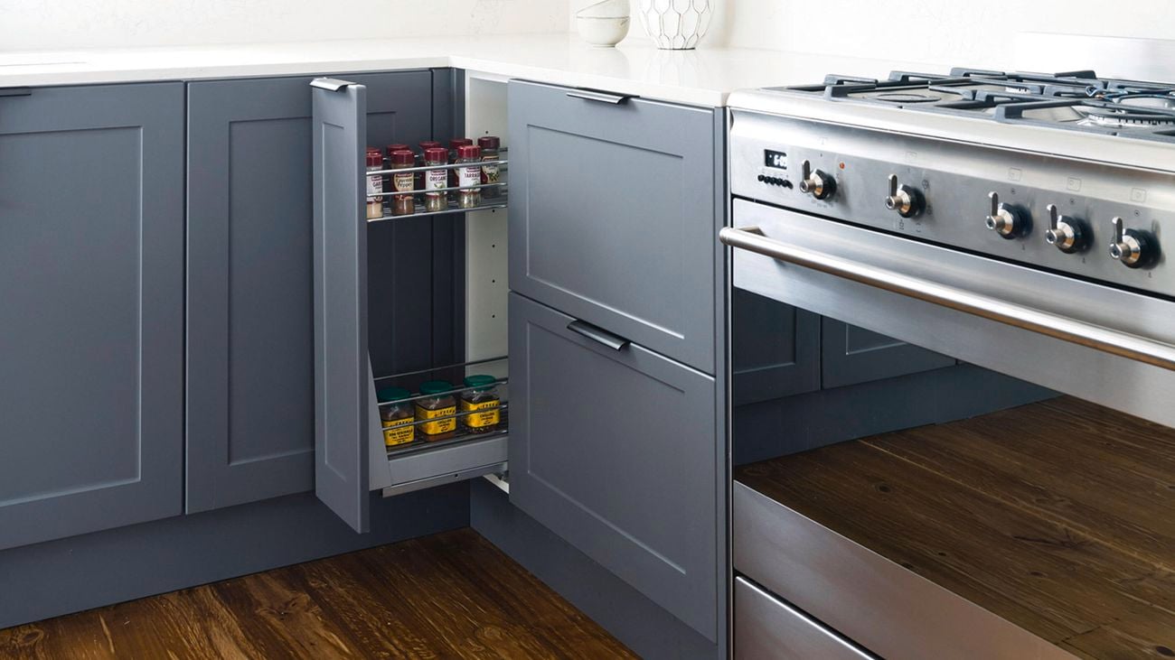 Kaboodle Kitchen 150mm 2 tier soft close pullout baskets inside a navy shaker-style cabinet.