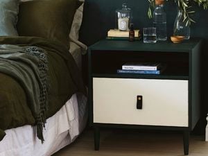 Black and white bedside table in bedroom.