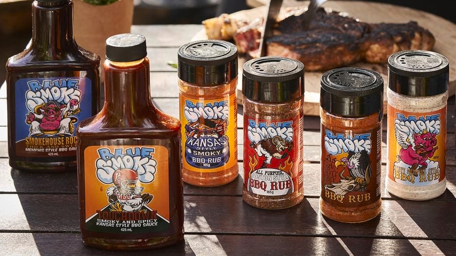 Sauces and rubs displayed on an outdoor table.