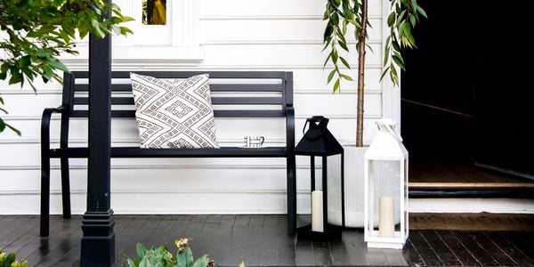Front porch of house with bench and plants