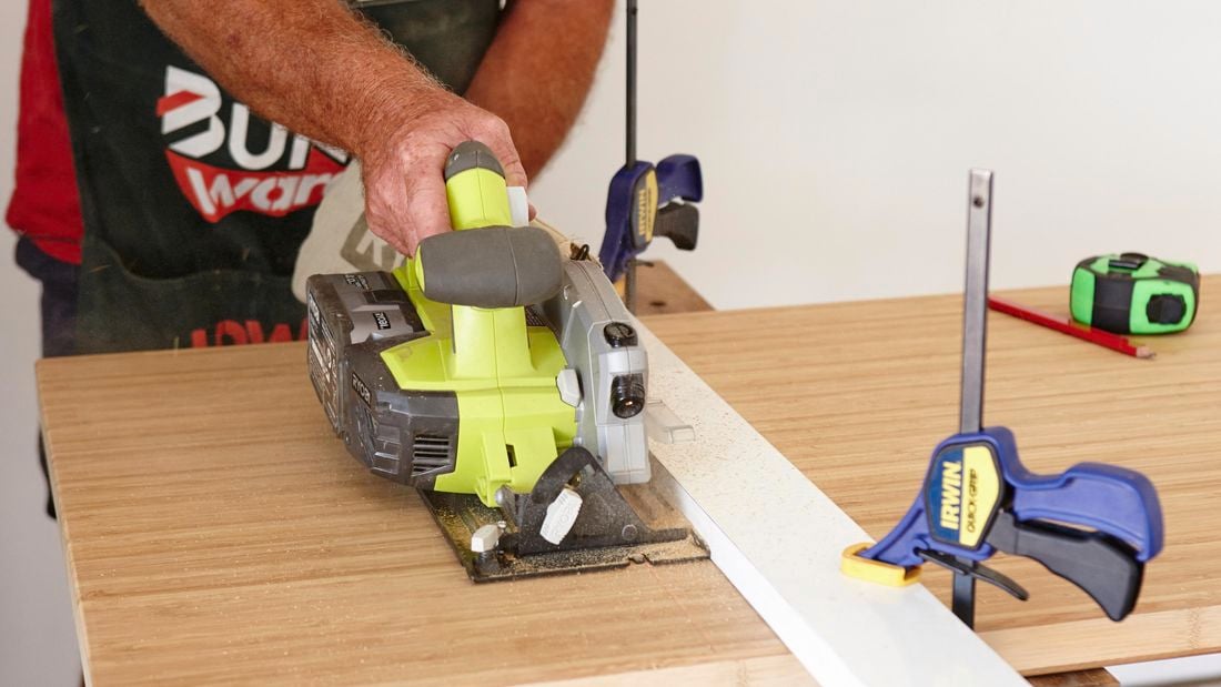 Bunnings team member using a circular saw to cut a piece of timber
