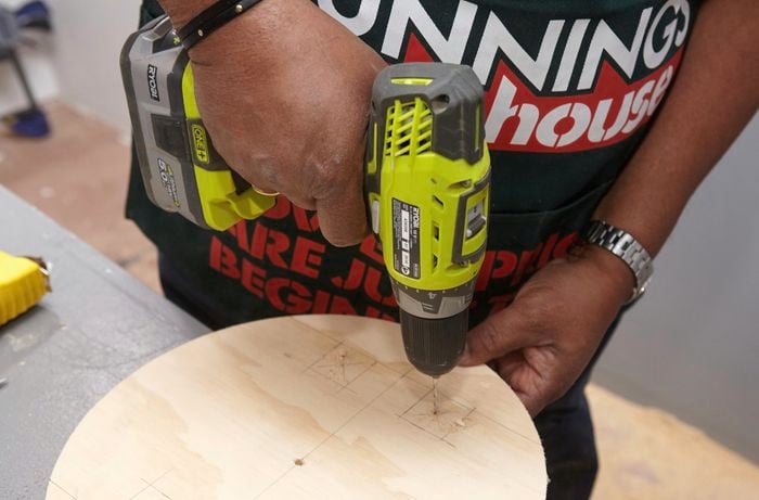 Holes being drilled into a stool seat