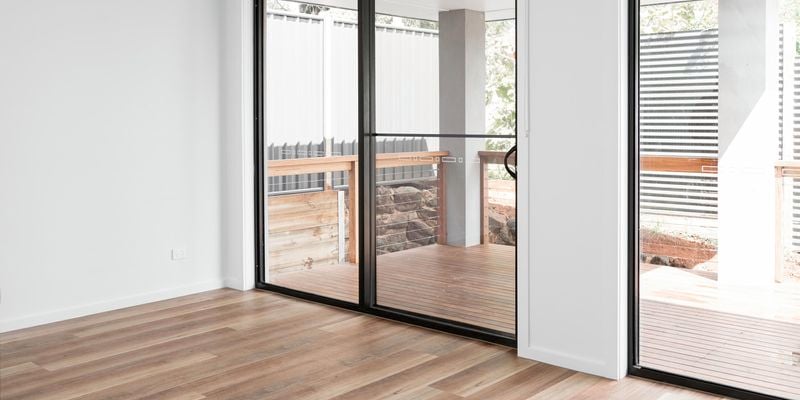 View from inside of house of sliding doors leading out to deck.