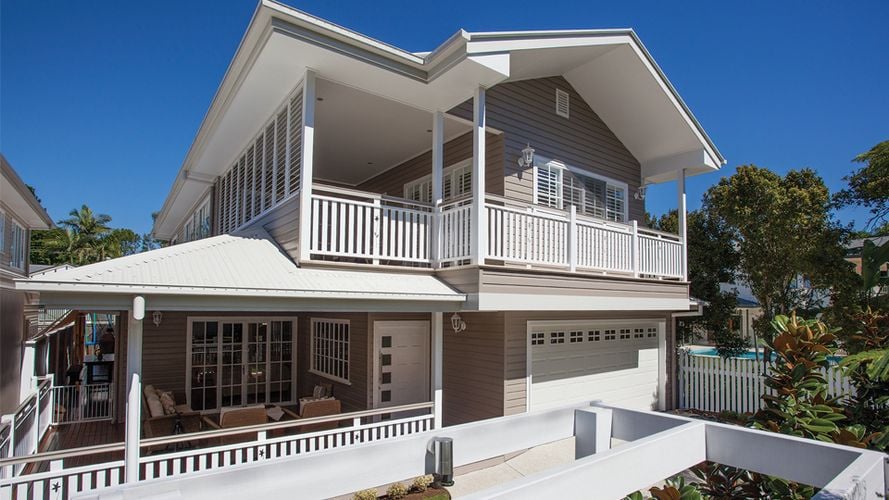 Exterior of a two-storey wooden house painted grey and white