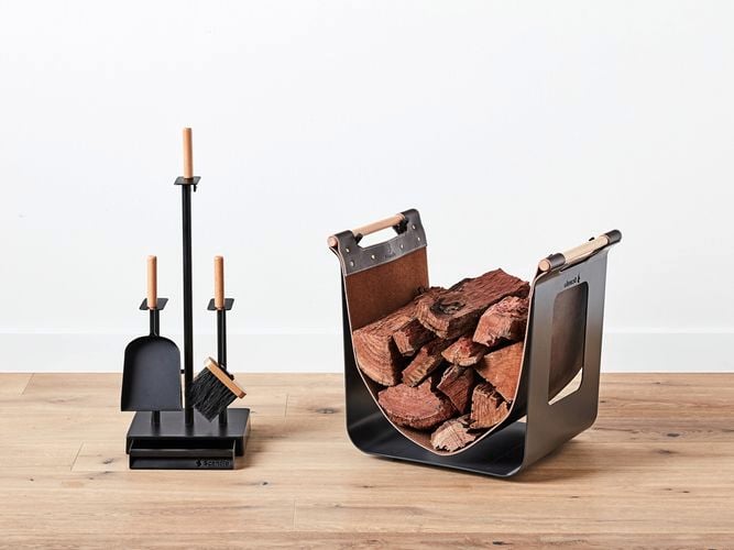 Wood heater accessories and a wood holder on timber flooring.