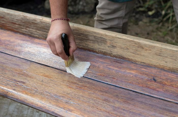An undercoat being applied to a bench