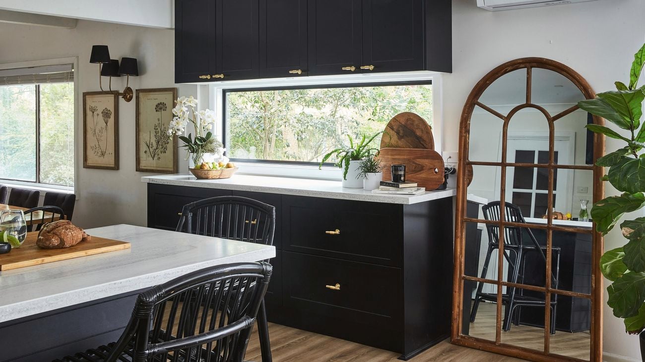 Modern monochrome kitchen with fresh flowers, and framed flower drawing with fresh bread on the becnhtop
