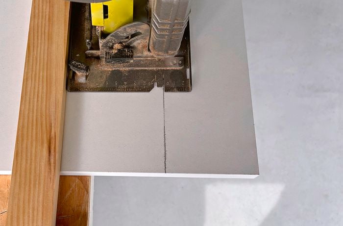 Close-up of circular saw cutting a piece of timber