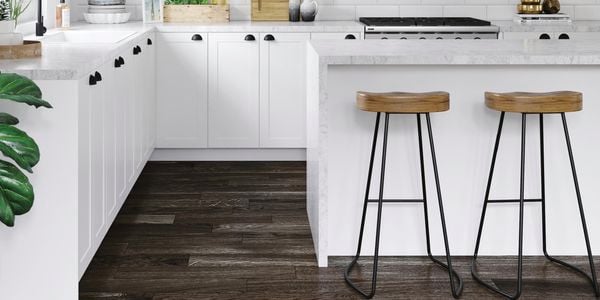 Kitchen with white benchtops, marble benchtop and white tile splashback.