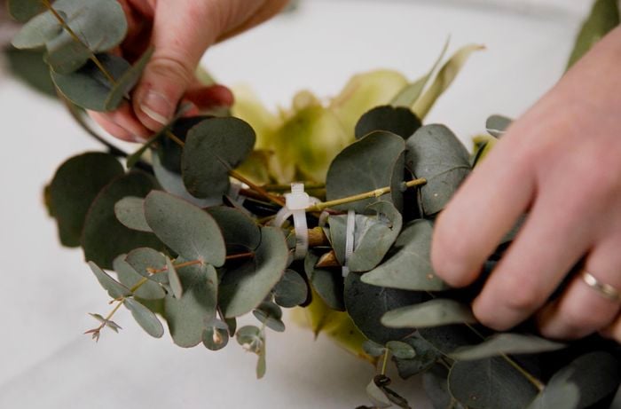 Close up of securing native flowers together