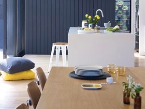 Kitchen with dining table and kitchen island and dark blue walls