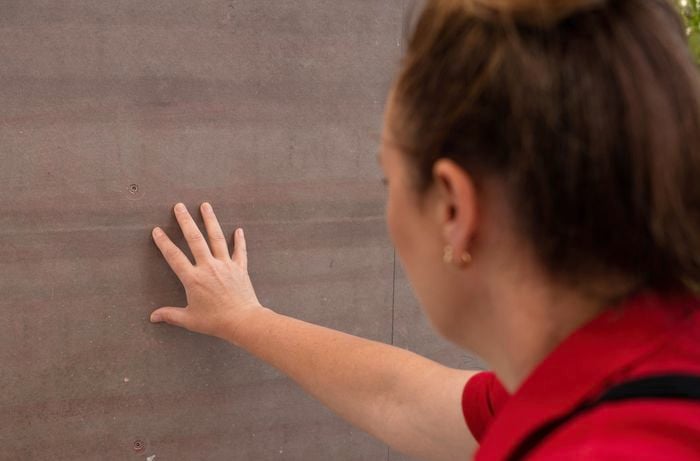 A woman touching the wall.