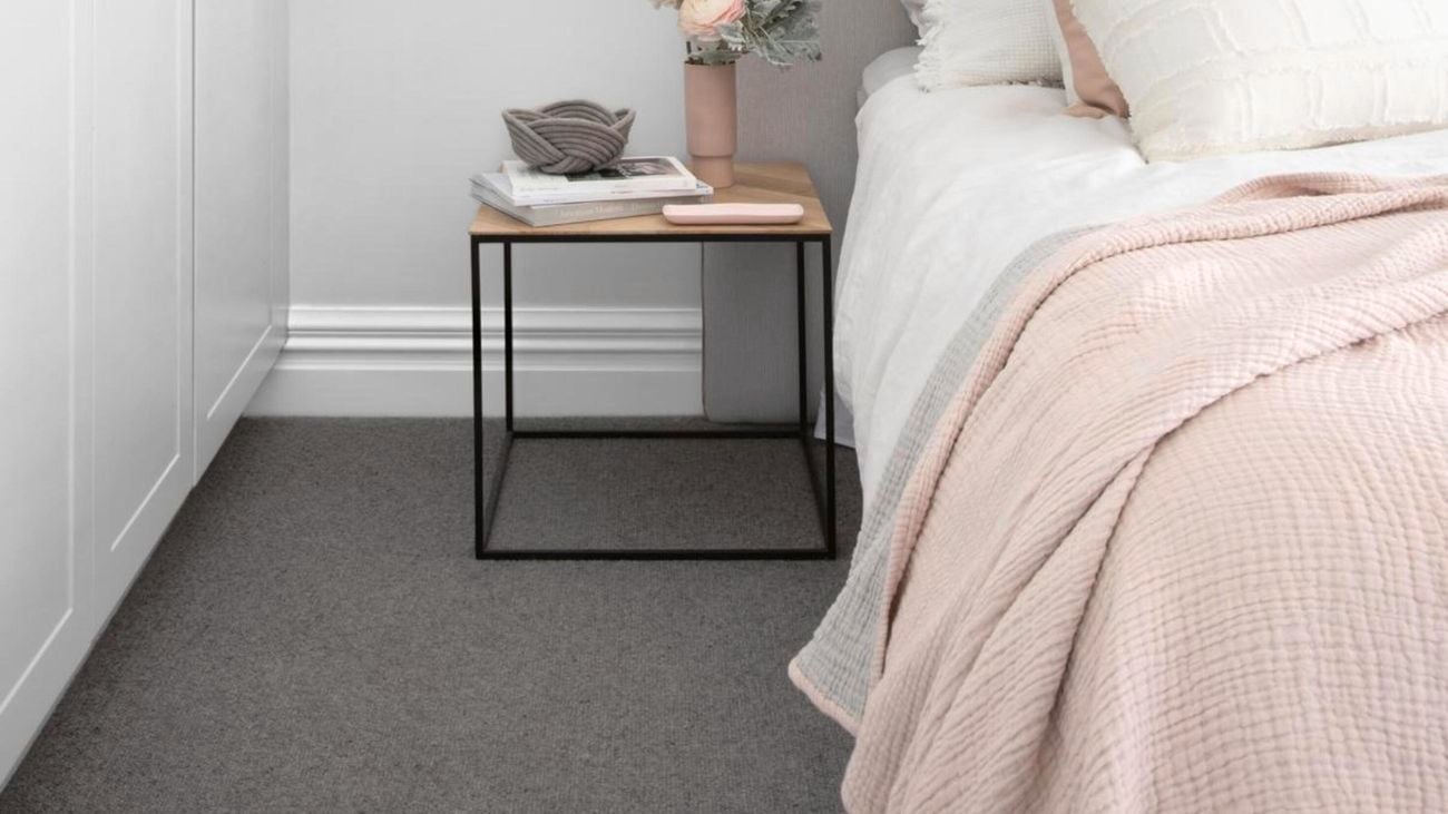 Bed, bedside table, flowers.