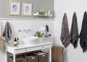 Bathroom with towels and other items hanging on hooks