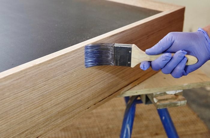Varnish being applied to a dog bed