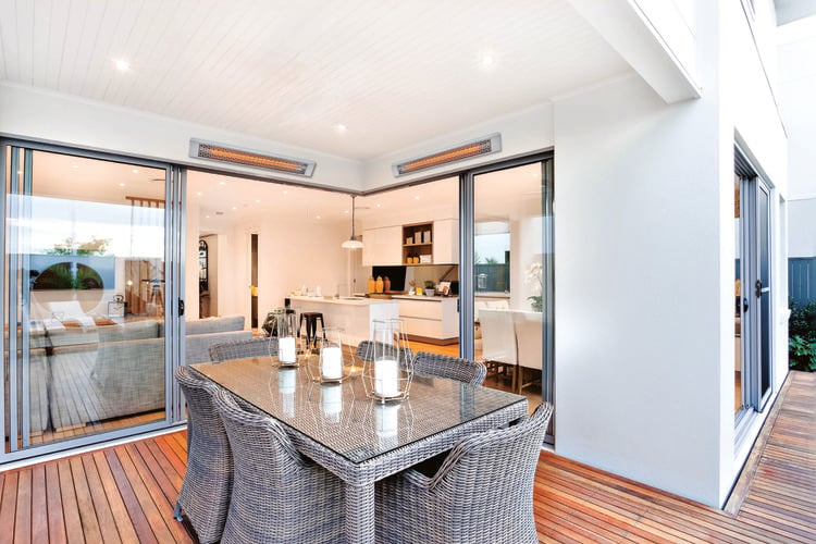 Heat lamps mounted above bay doors for a dining area on the back deck