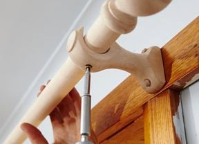 Attaching a curtain rod to timber bracket using a cordless driver