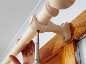 Attaching a curtain rod to timber bracket using a cordless driver
