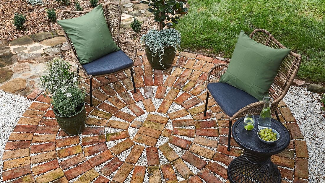 A completed brick paved patio complete with two lounge chairs