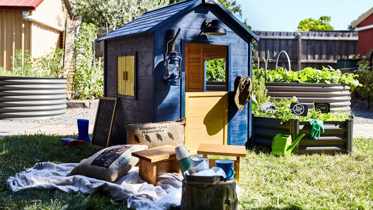 Navy kids cubby house with picnic setup out front.