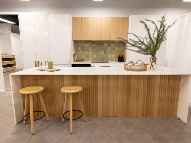 A modern kitchen with a white marble benchtop.