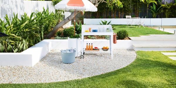 Drinks trolley set up in backyard with umbrella