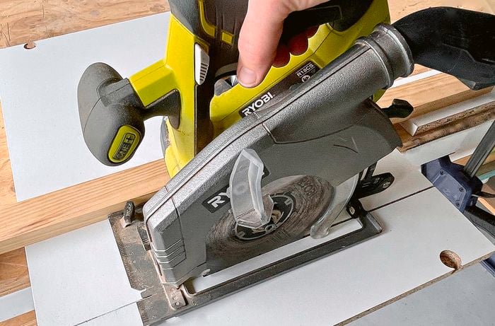 A circular saw being used to cut a cupboard piece