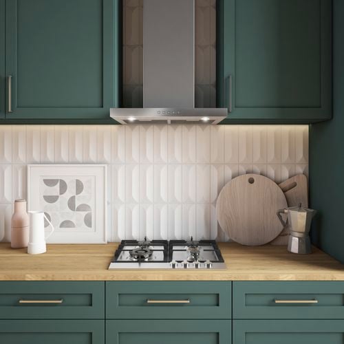 Green kitchen cabinets, timber benchtop, cooktop and 60cm canopy rangehood in stainless steel.