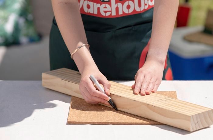 Person making timber with sharpie.