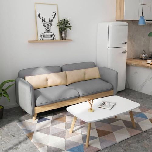 This modern grey sofa features plush cushions and a natural wood base for a clean, relaxed look. I/N: 0593611