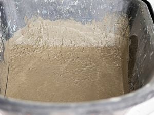 Mixed concrete in a black wheelbarrow