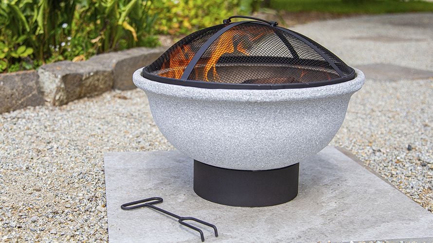 An enclosed brazier in a gravel courtyard