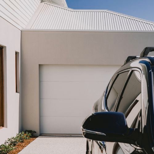 Modern house with white metal roof and garage