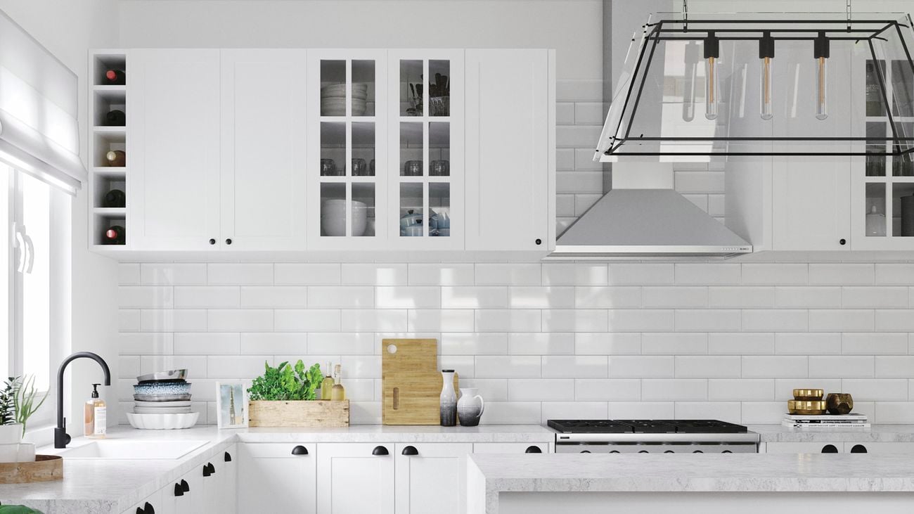 Kitchen with white benchtops, marble benchtop and white tile splashback.