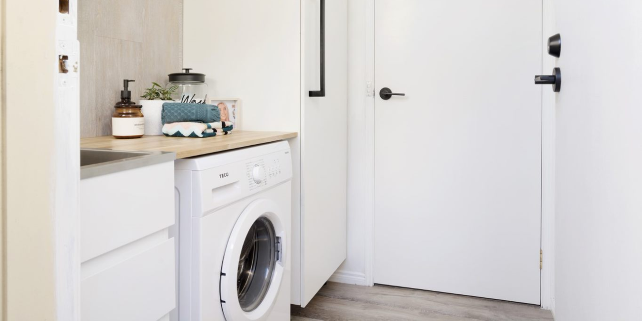 Laundry with washing machine and sink.